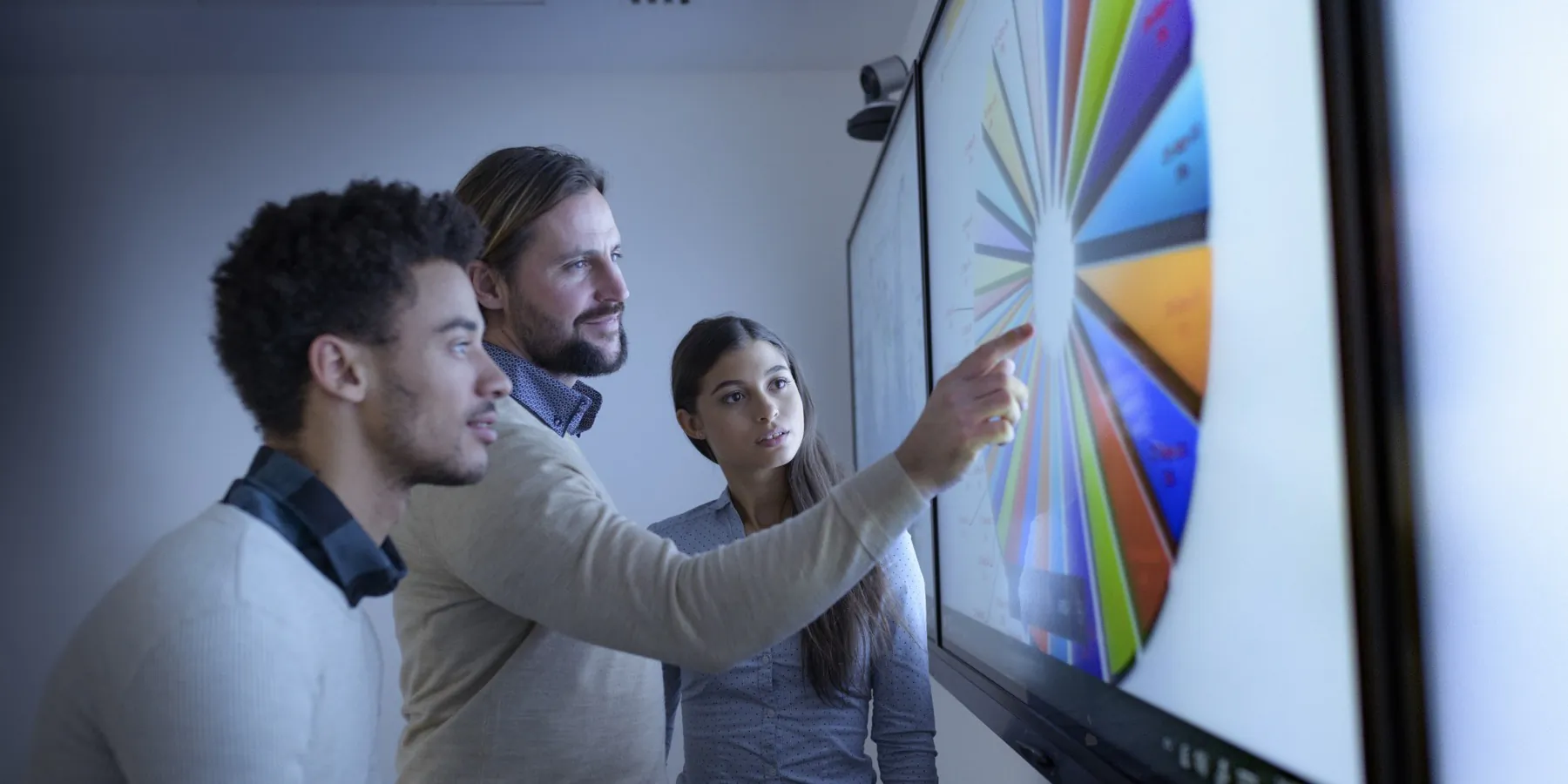 A team reviewing a system diagram on a large display