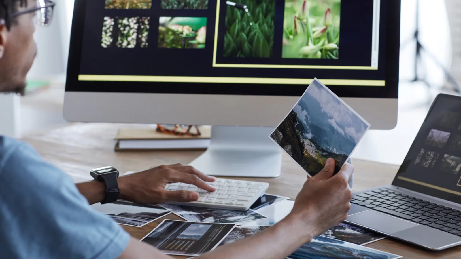 A designer arranging a website layout on a large screen