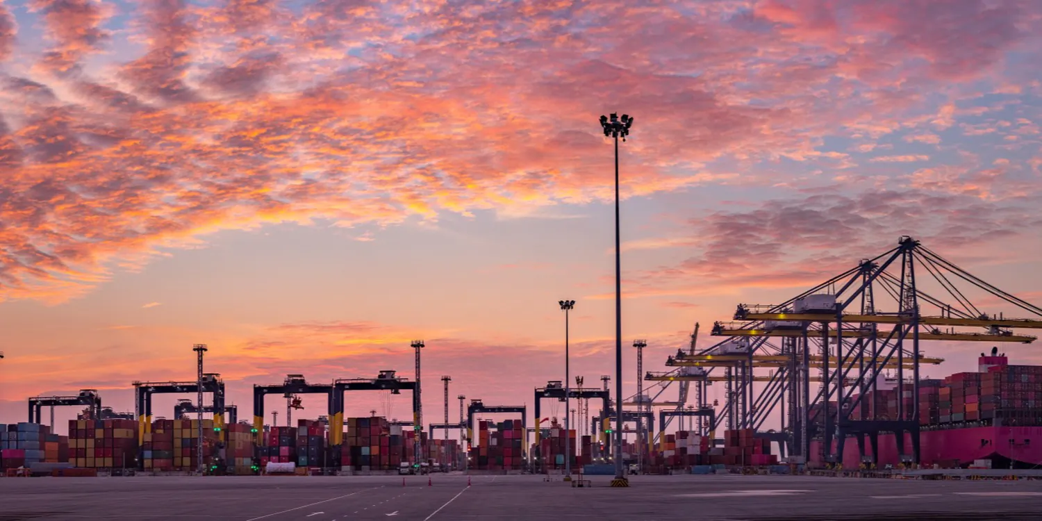 Containers stacked at a port terminal at dusk