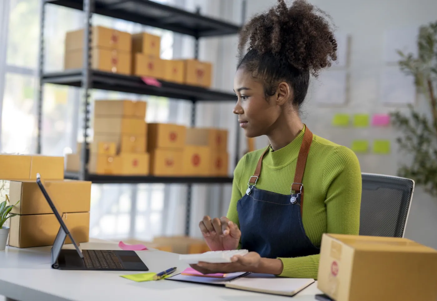 A retail assistant packing an online order at a store counter